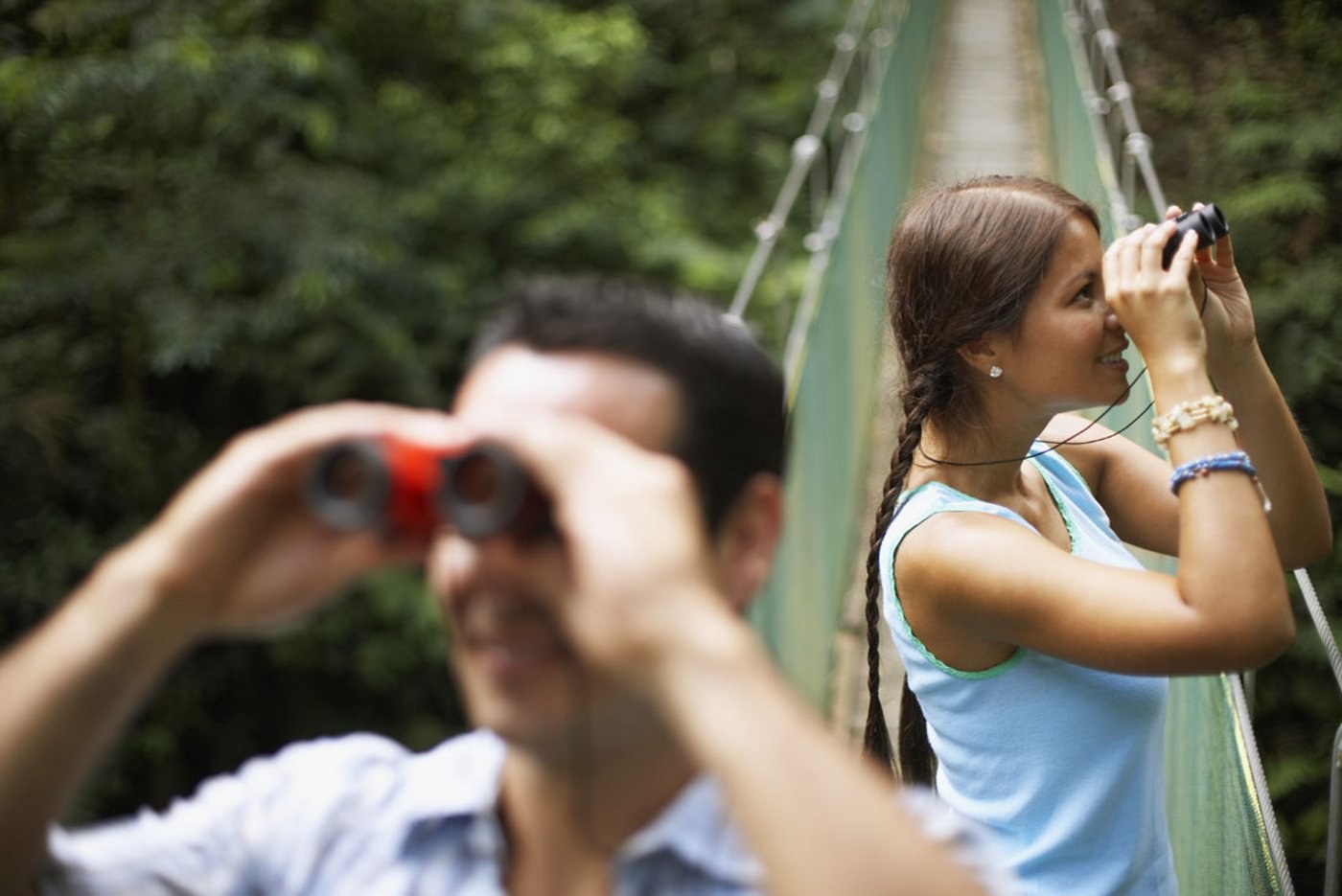 A child and adult looking through binoculars in Costa Rica, from Intrepid trip photography
