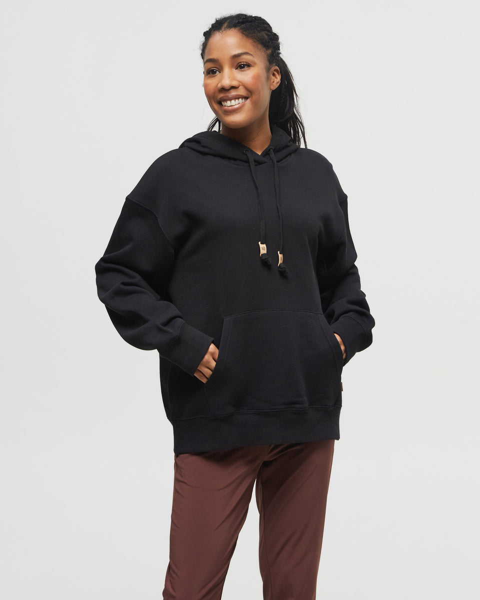 Woman wearing a black tentree TreeFleece Relaxed Hoodie